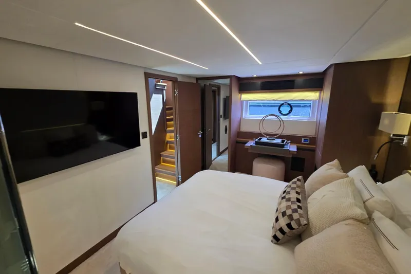 Slide: The Image of Luxurious interior of 2022 Prestige X70 yacht bedroom with modern decor and large TV. - 14