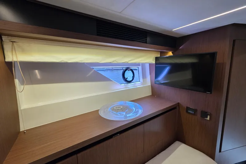 Slide: The Image of Luxurious interior of 2022 Prestige X70 yacht with TV and window view. - 17