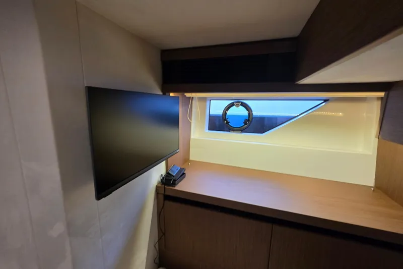 Slide: The Image of Modern interior of 2022 Prestige X70 yacht with TV and window view. - 19