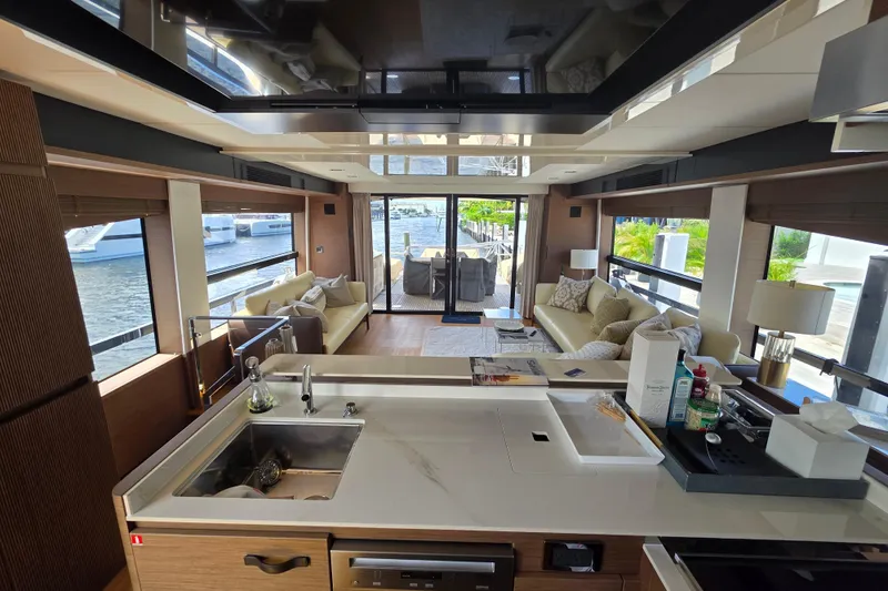 Slide: The Image of Luxurious interior of a 2022 Prestige X70 yacht with modern kitchen and spacious seating area. - 6