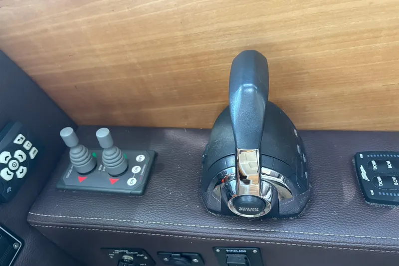 Slide: The Image of Control panel of a 2013 Cutwater C-28 boat with throttle and joystick controls. - 12