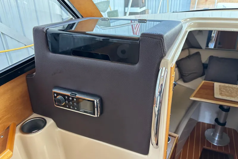 Slide: The Image of 2013 Cutwater C-28 interior with radio, cup holder, and cozy seating area. - 15