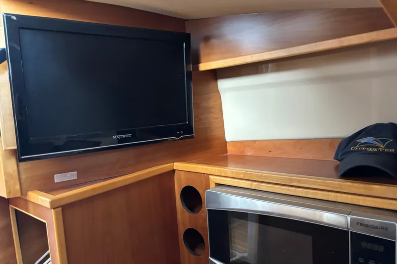 Slide: The Image of Interior of 2013 Cutwater C-28 with TV, microwave, and branded cap. - 20