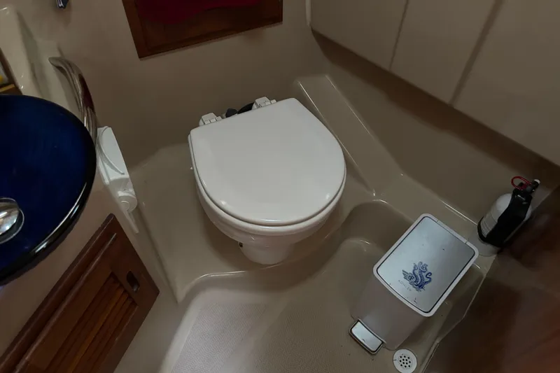 Slide: The Image of 2013 Cutwater C-28 boat bathroom with toilet, sink, and fire extinguisher. - 21