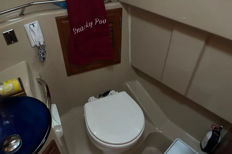 Slide: The Image of 2013 Cutwater C-28 boat bathroom with toilet, sink, and red towel. - 22