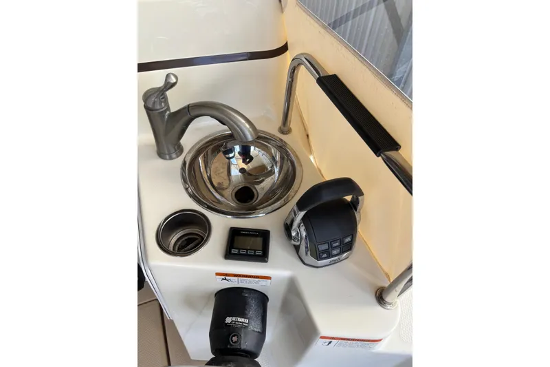 Slide: The Image of 2013 Cutwater C-28 boat sink area with faucet, control panel, and handle. - 3