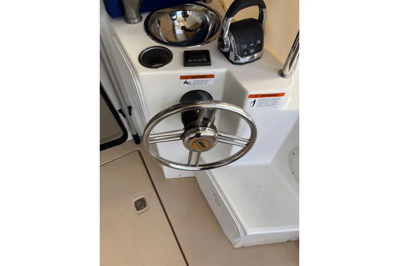 Slide: The Image of Steering wheel and controls of a 2013 Cutwater C-28 boat cockpit. - 4