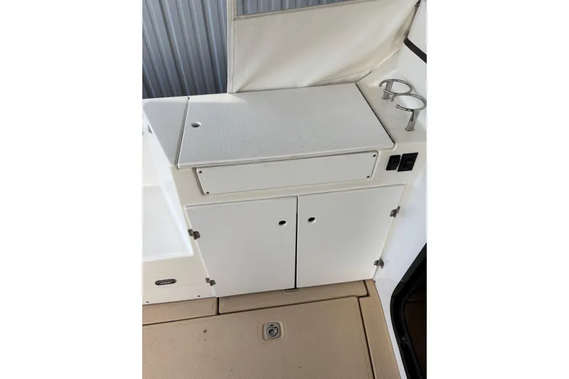 Slide: The Image of 2013 Cutwater C-28 boat interior with storage cabinets and cup holders. - 5