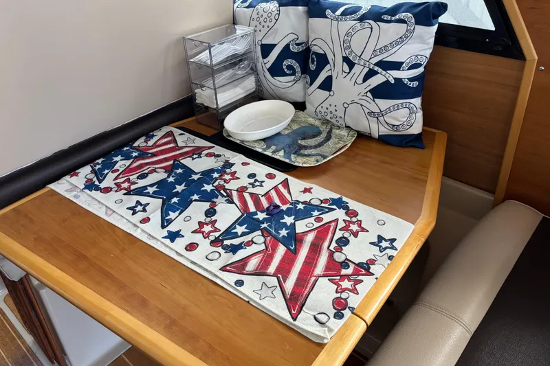 Slide: The Image of Cozy dining area in 2013 Cutwater C-28 boat with nautical decor and patriotic table setting. - 8