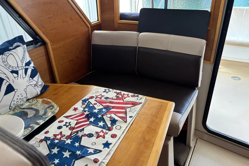 Slide: The Image of Cozy interior of 2013 Cutwater C-28 boat with patriotic decor and nautical-themed cushions. - 9