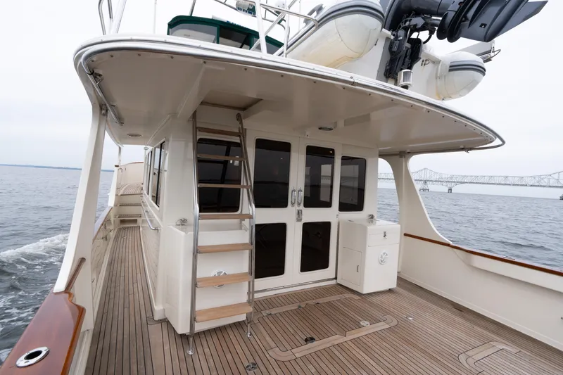 Slide: The Image of 2007 Fleming 55 yacht deck with wooden flooring and ocean view. - 10