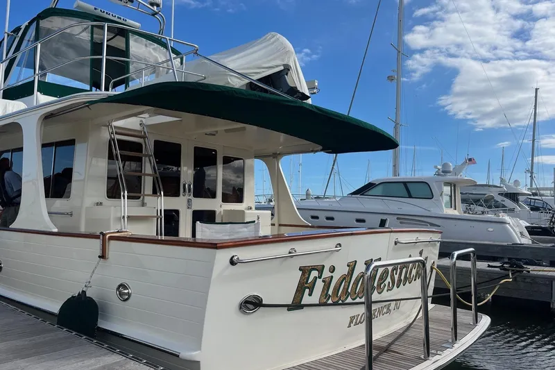 Slide: The Image of Luxury 2007 Fleming 55 yacht docked at marina under blue sky. - 11