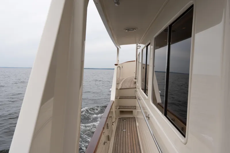 Slide: The Image of Side view of 2007 Fleming 55 yacht cruising on open water. - 14