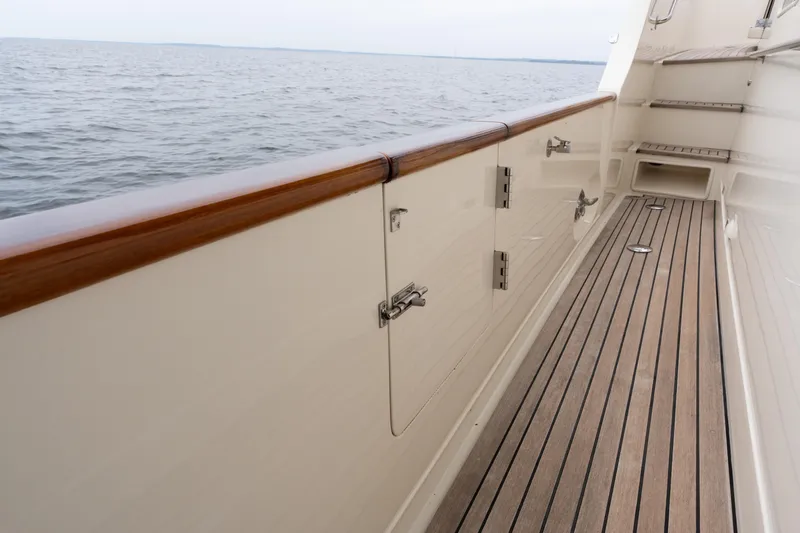 Slide: The Image of Side deck of a 2007 Fleming 55 yacht with wooden railings and ocean view. - 15