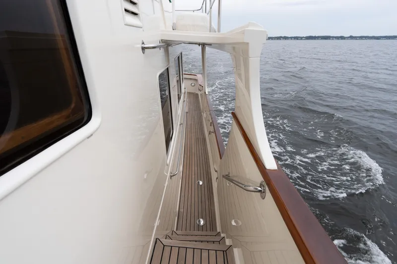 Slide: The Image of Side deck view of 2007 Fleming 55 yacht cruising on open water. - 17