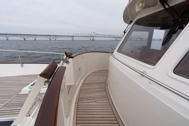 Slide: The Image of 2007 Fleming 55 yacht with wooden deck, bridge view, and overcast sky. - 19
