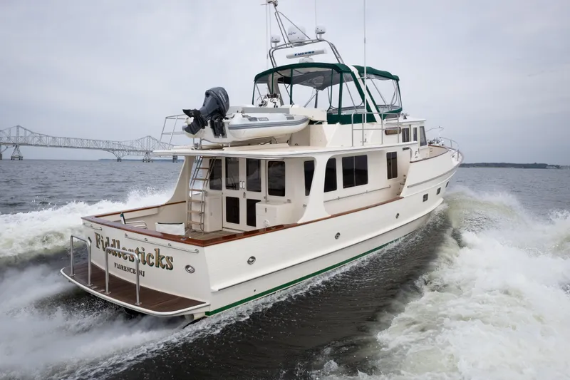 Slide: The Image of 2007 Fleming 55 yacht cruising on water with bridge in background. - 2