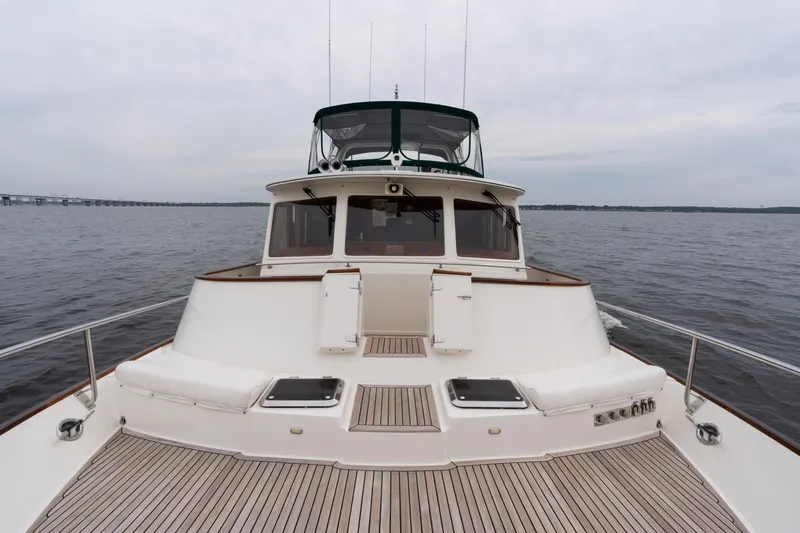 Slide: The Image of 2007 Fleming 55 yacht on open water, showcasing spacious deck and elegant design. - 23