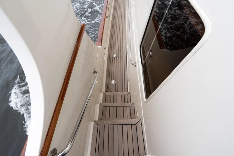 Slide: The Image of Side deck of a 2007 Fleming 55 yacht with teak flooring and railing. - 28