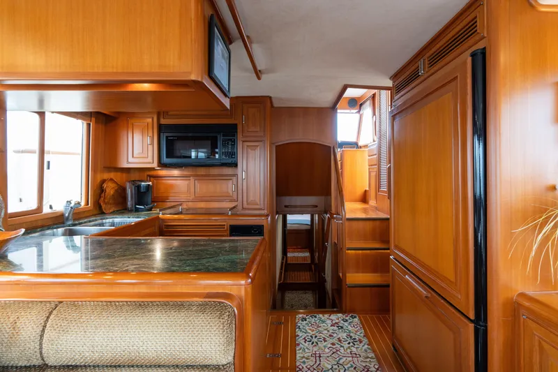 Slide: The Image of Luxurious 2007 Fleming 55 yacht interior with wood cabinetry and modern kitchen amenities. - 40