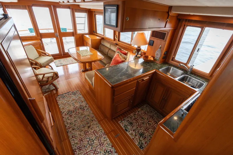 Slide: The Image of Luxurious 2007 Fleming 55 yacht interior with elegant wood finishes and cozy seating area. - 41