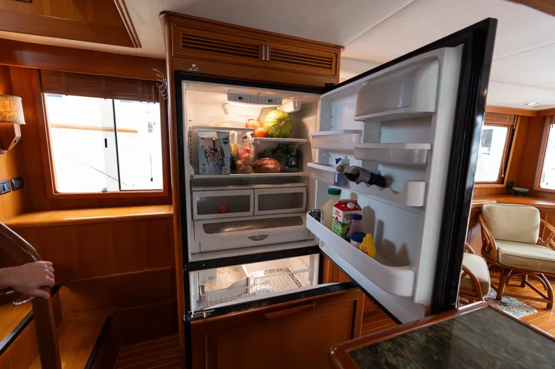 Slide: The Image of Open refrigerator in 2007 Fleming 55 yacht interior, stocked with various food items. - 44