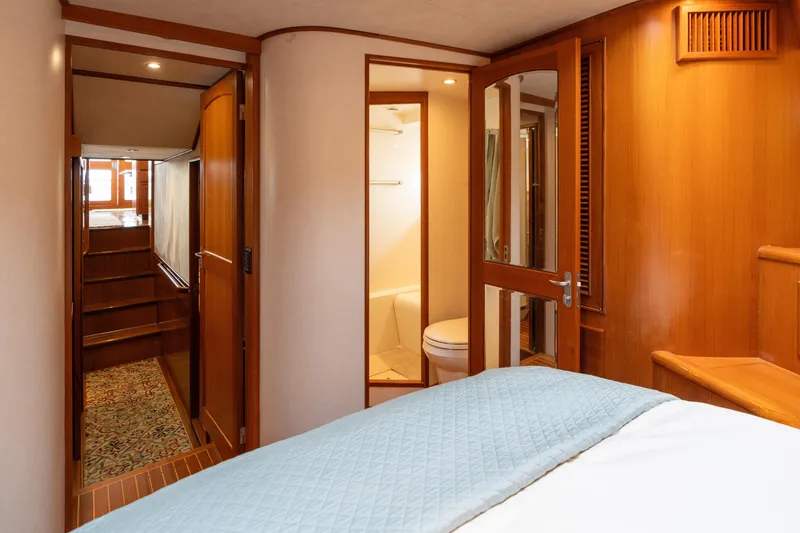 Slide: The Image of Luxurious cabin interior of a 2007 Fleming 55 yacht with cozy bedding and wooden furnishings. - 49