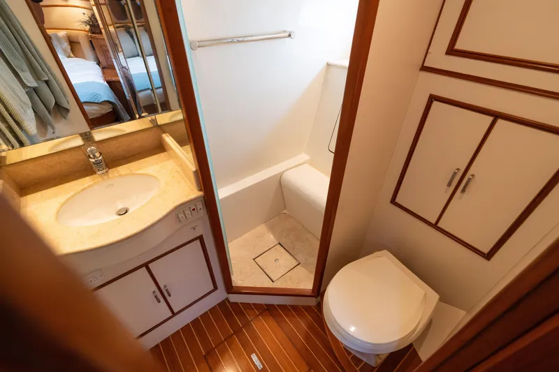 Slide: The Image of Luxurious 2007 Fleming 55 yacht interior with wood finishes, bathroom, and shower. - 51