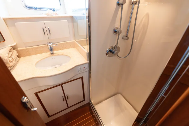Slide: The Image of Luxurious wooden interior hallway of a 2007 Fleming 55 yacht with shower and carpet. - 53