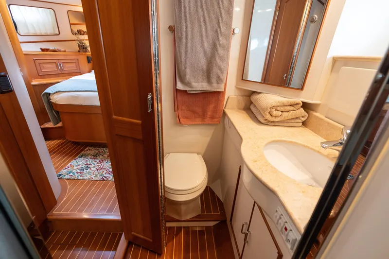 Slide: The Image of Luxurious bathroom in 2007 Fleming 55 yacht with shower and sink. - 54