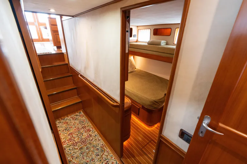 Slide: The Image of Luxurious 2007 Fleming 55 yacht bathroom with wood accents and cozy bedroom view. - 55