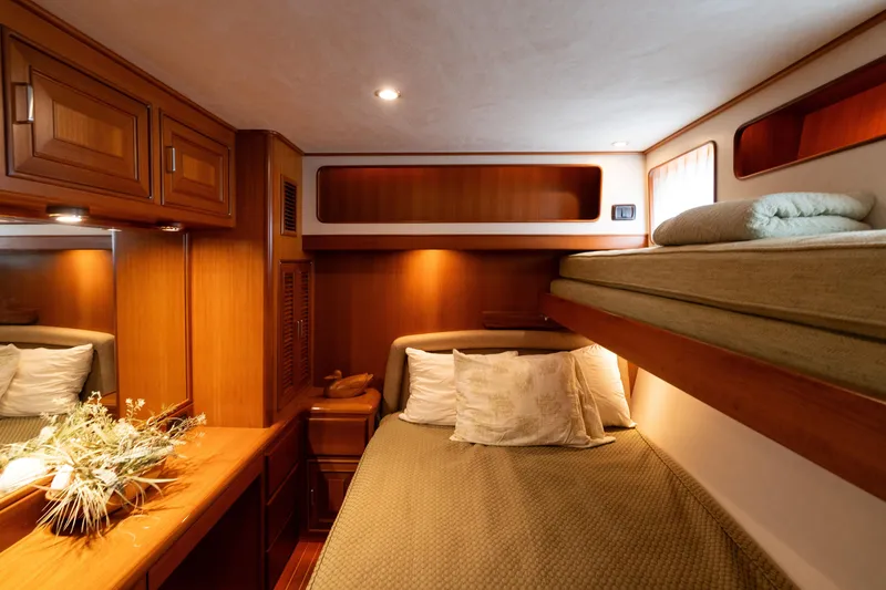 Slide: The Image of Luxurious cabin interior of 2007 Fleming 55 yacht with cozy bedding and elegant wood finish. - 57