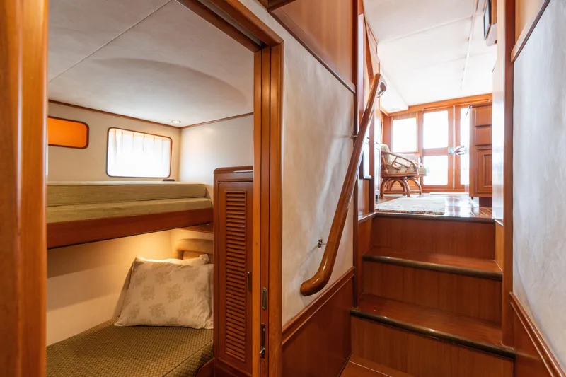 Slide: The Image of Luxurious wooden interior of a 2007 Fleming 55 yacht cabin with elegant decor. - 59