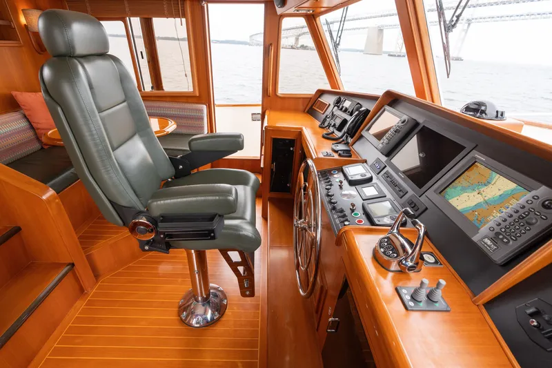 Slide: The Image of Luxurious 2007 Fleming 55 yacht helm with wood interior and modern navigation equipment. - 62