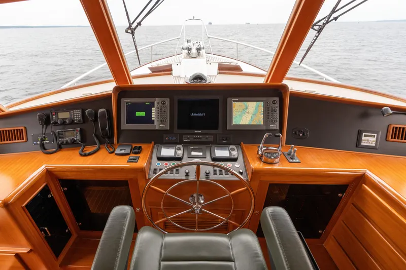 Slide: The Image of Luxurious 2007 Fleming 55 yacht helm with navigation equipment and wooden finish on open water. - 66