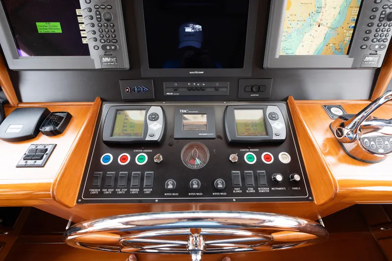 Slide: The Image of Control panel of a 2007 Fleming 55 yacht with navigation instruments and steering wheel. - 68
