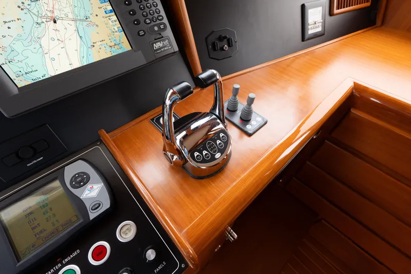 Slide: The Image of Control panel of 2007 Fleming 55 yacht with navigation and throttle controls. - 69