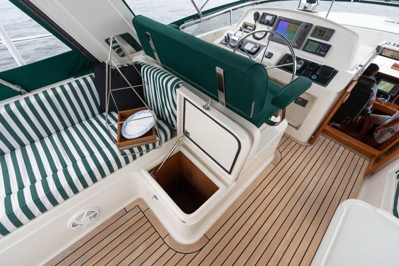 Slide: The Image of Luxurious 2007 Fleming 55 yacht interior with striped seating and navigation equipment. - 72