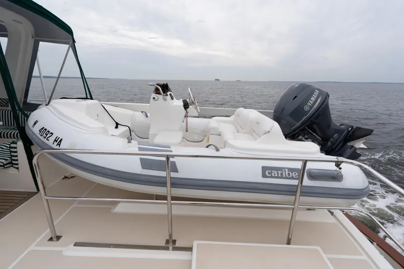 Slide: The Image of Inflatable Caribe boat with Yamaha motor on 2007 Fleming 55 yacht deck. - 81