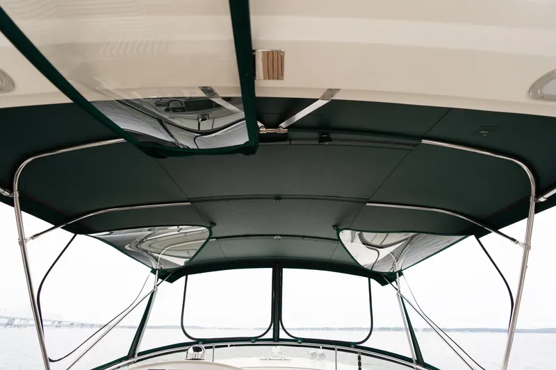 Slide: The Image of 2007 Fleming 55 yacht interior with striped seating, overlooking a bridge on the water. - 85