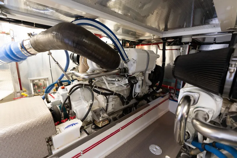 Slide: The Image of Engine room of a 2007 Fleming 55 yacht, showcasing dual engines and mechanical systems. - 88