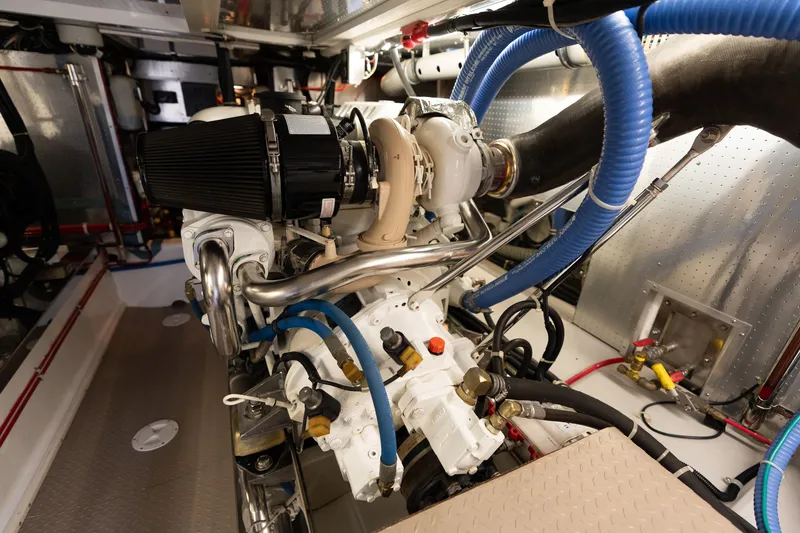 Slide: The Image of Engine room of a 2007 Fleming 55 yacht, showcasing detailed mechanical components. - 89