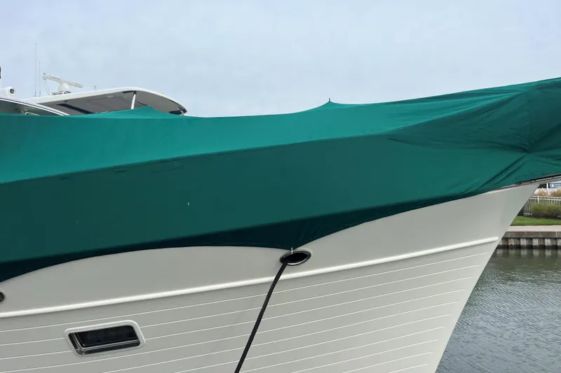 Slide: The Image of 2007 Fleming 55 yacht with green sunshade docked at marina. - 98