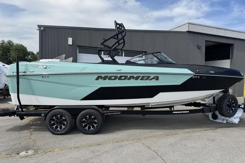 The Image of 2025 Moomba Tykon boat on trailer, sleek design, mint green and black color scheme. - 0