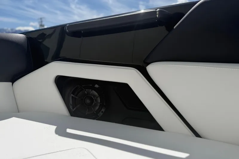 Slide: The Image of 2025 Moomba Tykon boat interior with sleek black and white design, featuring a built-in speaker. - 12