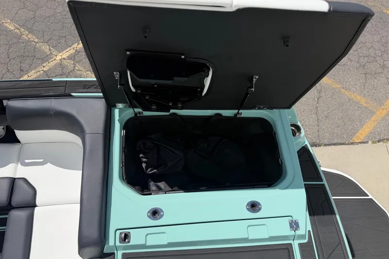 Slide: The Image of Moomba Tykon 2025 boat with open storage compartment lid. - 13