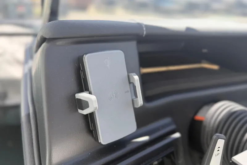 Slide: The Image of Dashboard of 2025 Moomba Tykon featuring a mounted wireless charging pad. - 17