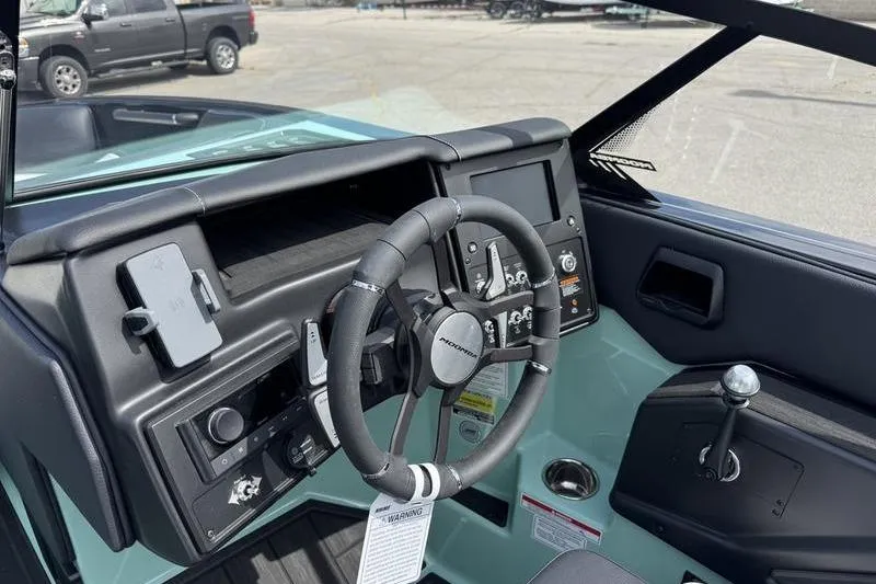Slide: The Image of 2025 Moomba Tykon boat dashboard with steering wheel and control panel. - 5
