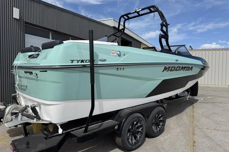 Slide: The Image of 2025 Moomba Tykon boat on trailer, sleek design, parked outdoors. - 8