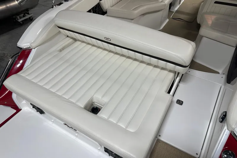 Slide: The Image of 2012 Cobalt A25 boat interior with white cushioned seating and sleek design. - 11